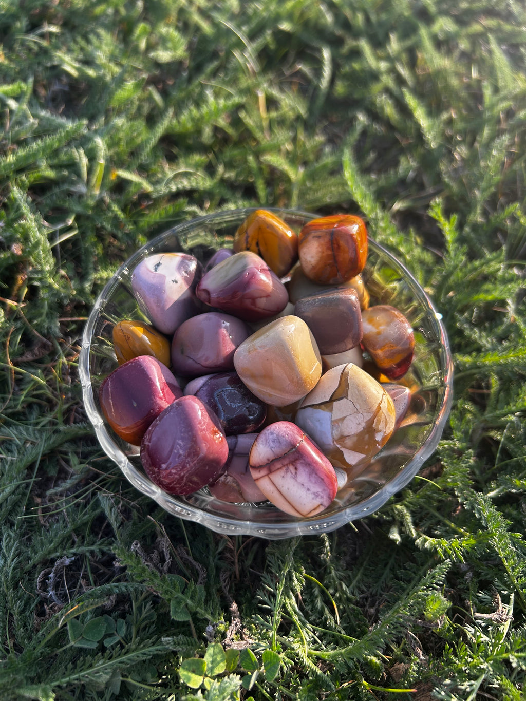 Mookaite Jasper tumbled stone with red, gold, cream, and brown coloring