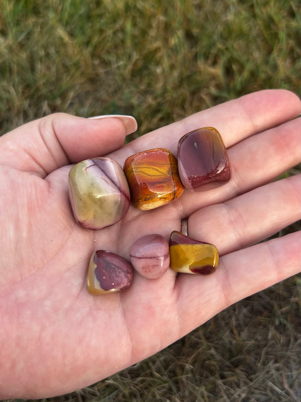 Close-up of Mookaite Jasper crystal with warm red and golden tones