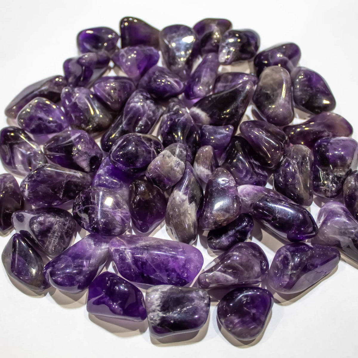 Polished purple Amethyst tumbled stones with natural color variations