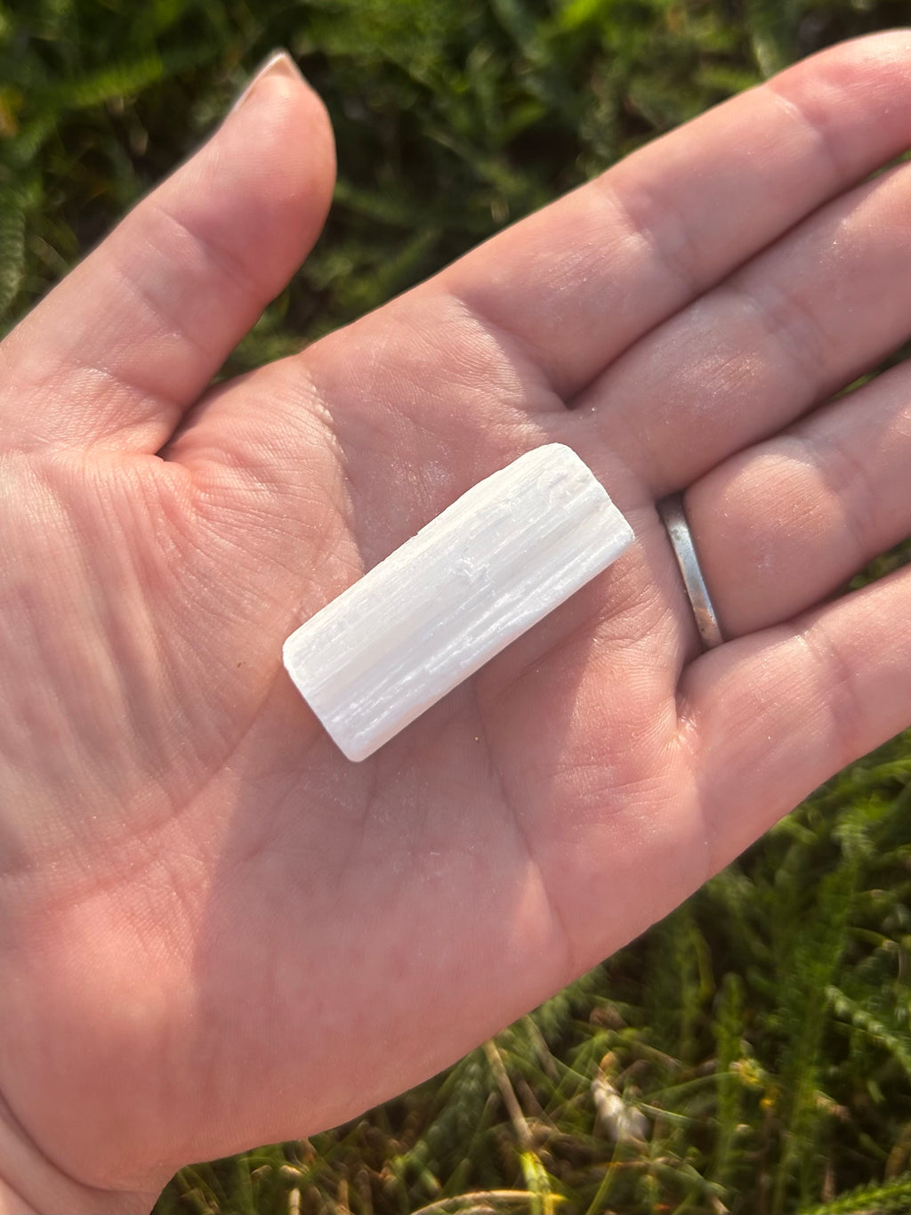 Close-up of natural Selenite stick showing satin-like crystal texture