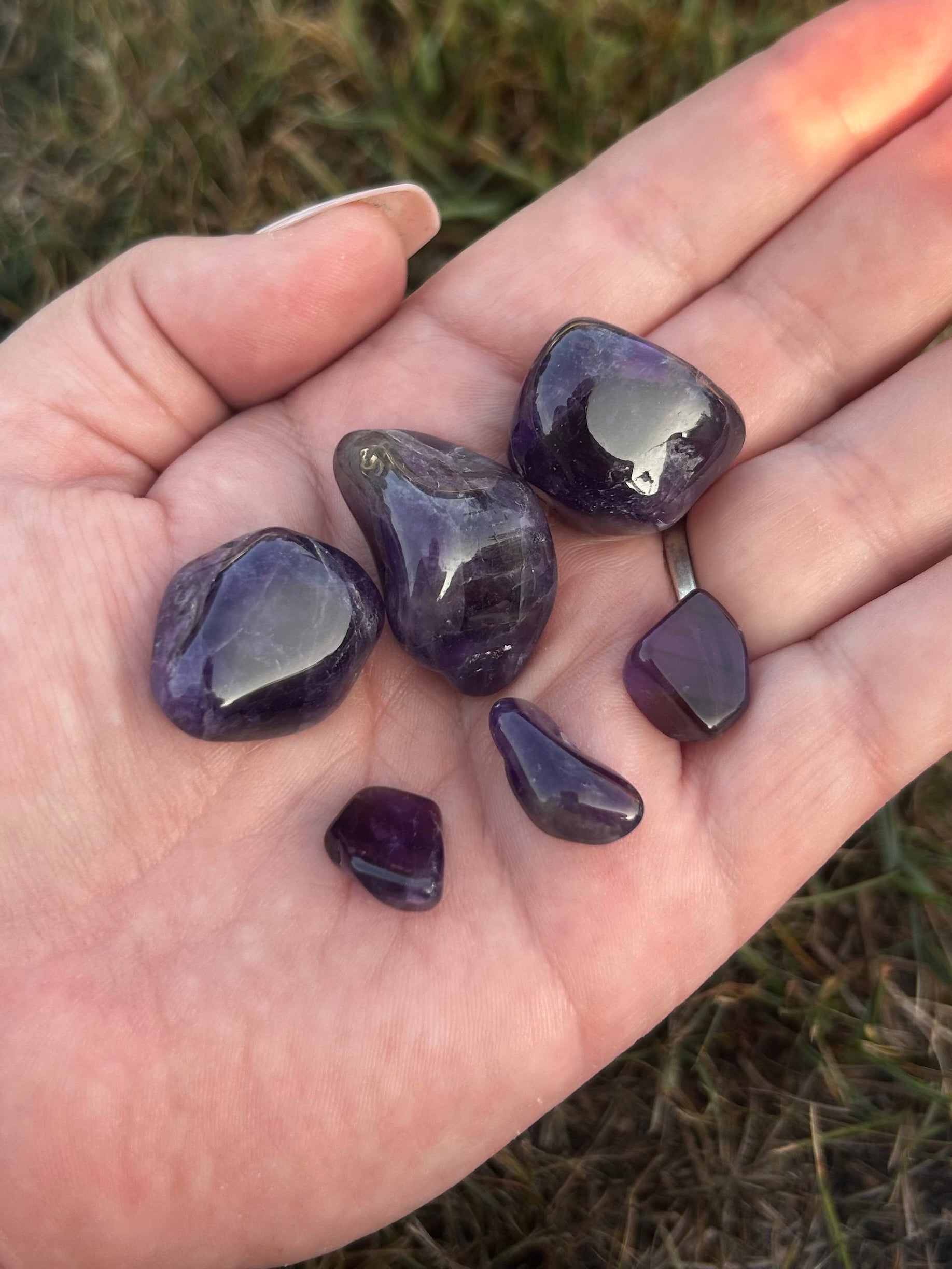 Amethyst tumbled stones in varying shades of purple