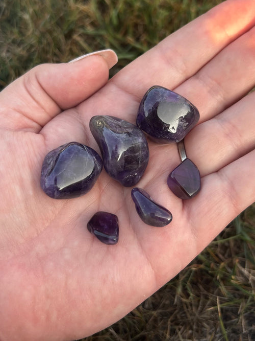 Amethyst tumbled stones in varying shades of purple