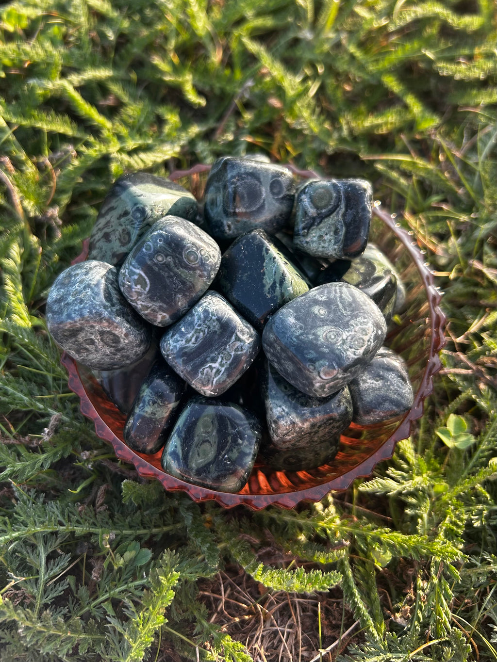 Natural Kambaba Jasper tumbled stones with dark green swirling patterns