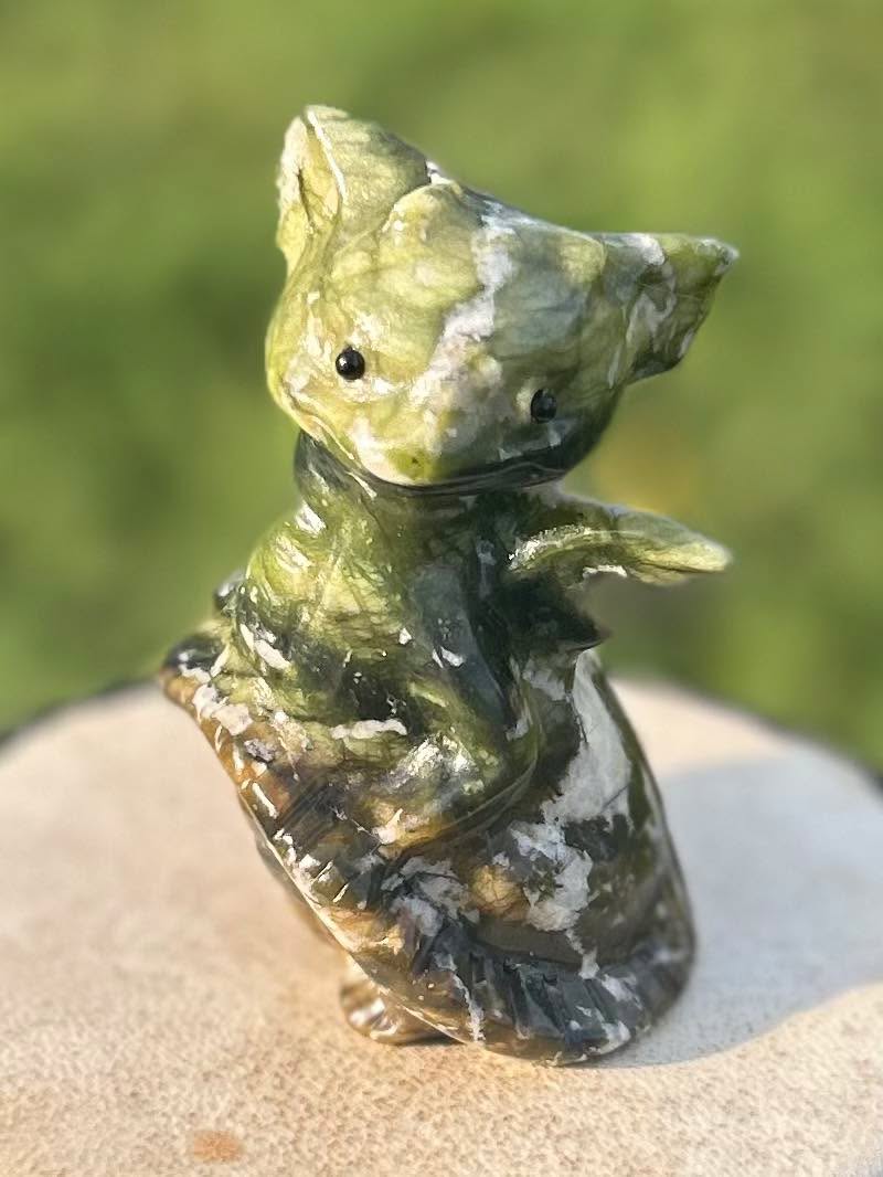 Close-up of The Dreamer natural nephrite jade crystal dragon carving
