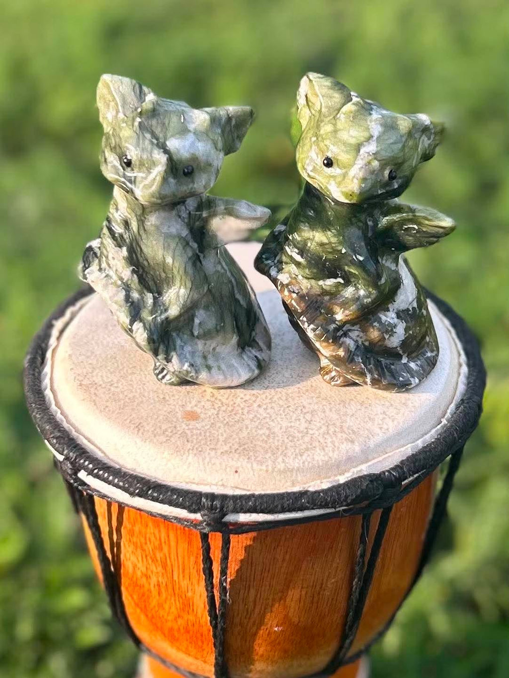 Two nephrite jade dragon carvings, The Guardian and The Dreamer, displayed side by side

