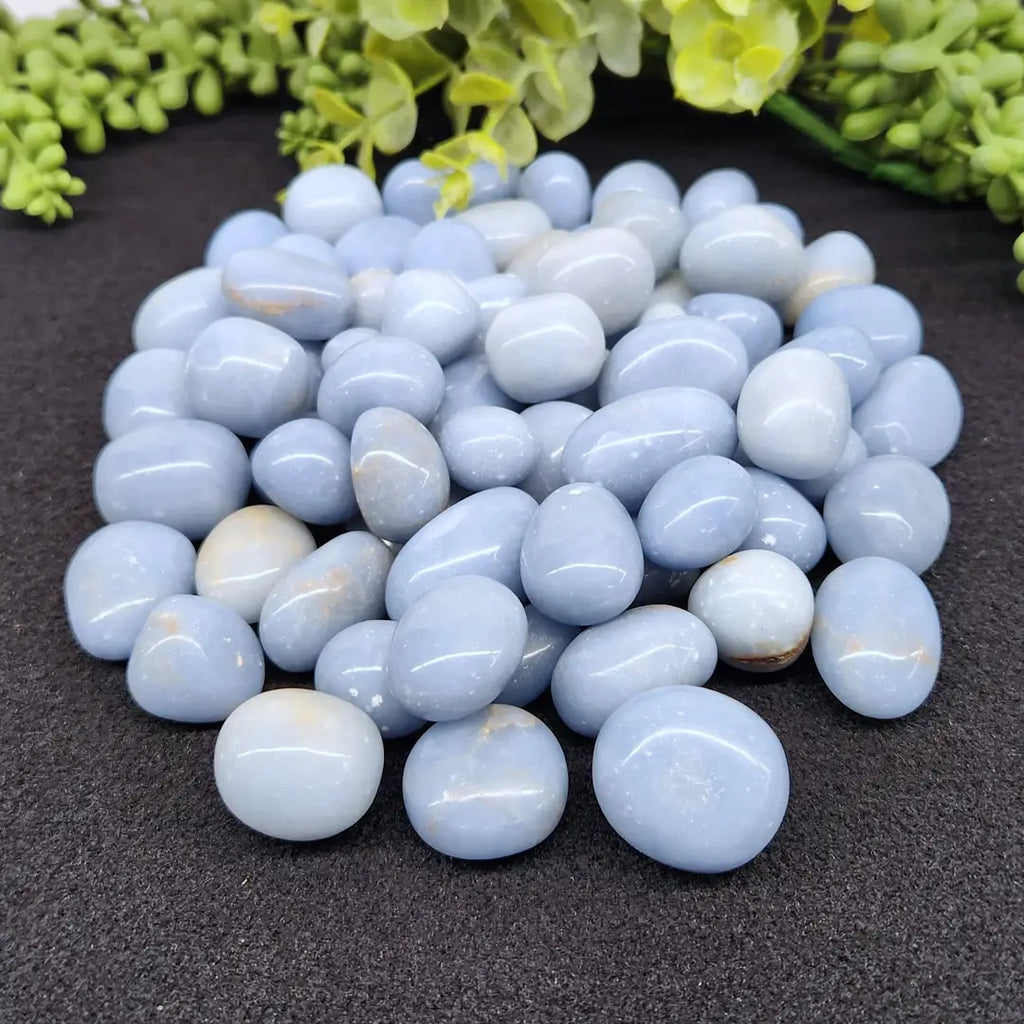 a pile of smooth polished angelite tumbles for connecting with your guides and meditation