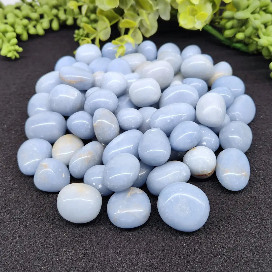 a pile of smooth polished angelite tumbles for connecting with your guides and meditation