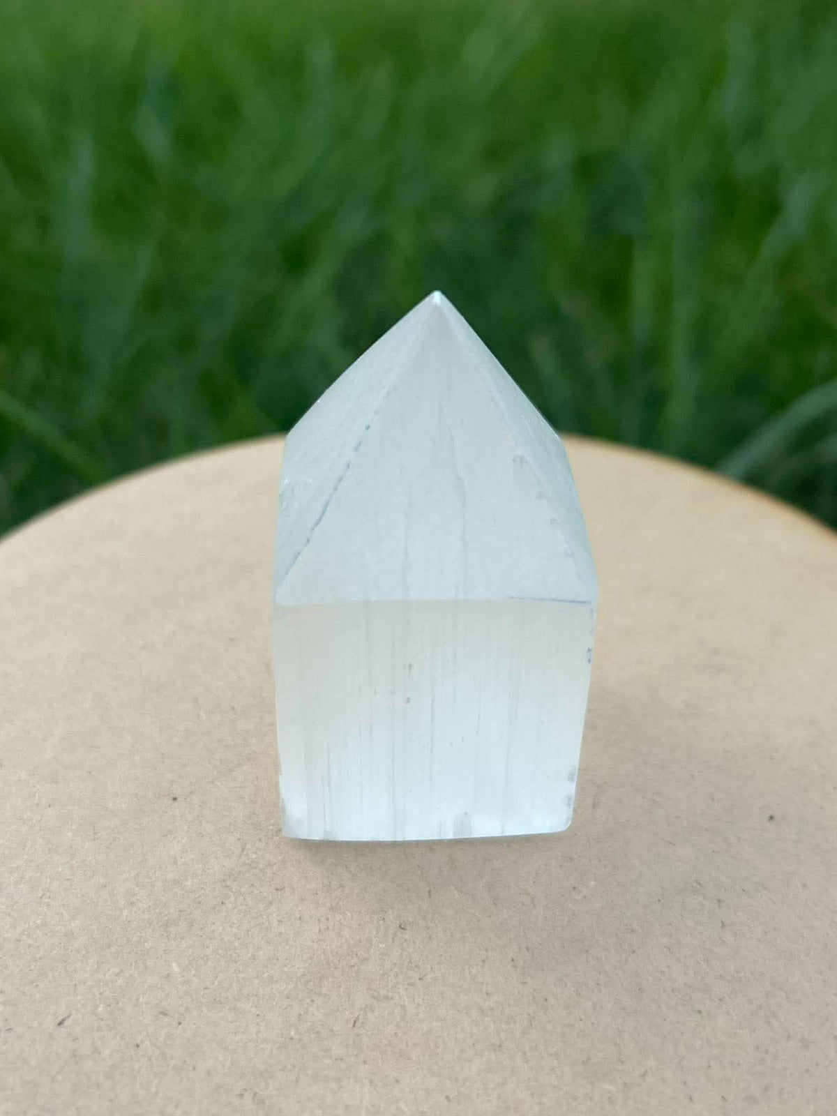 Polished white selenite crystal tower with pointed top