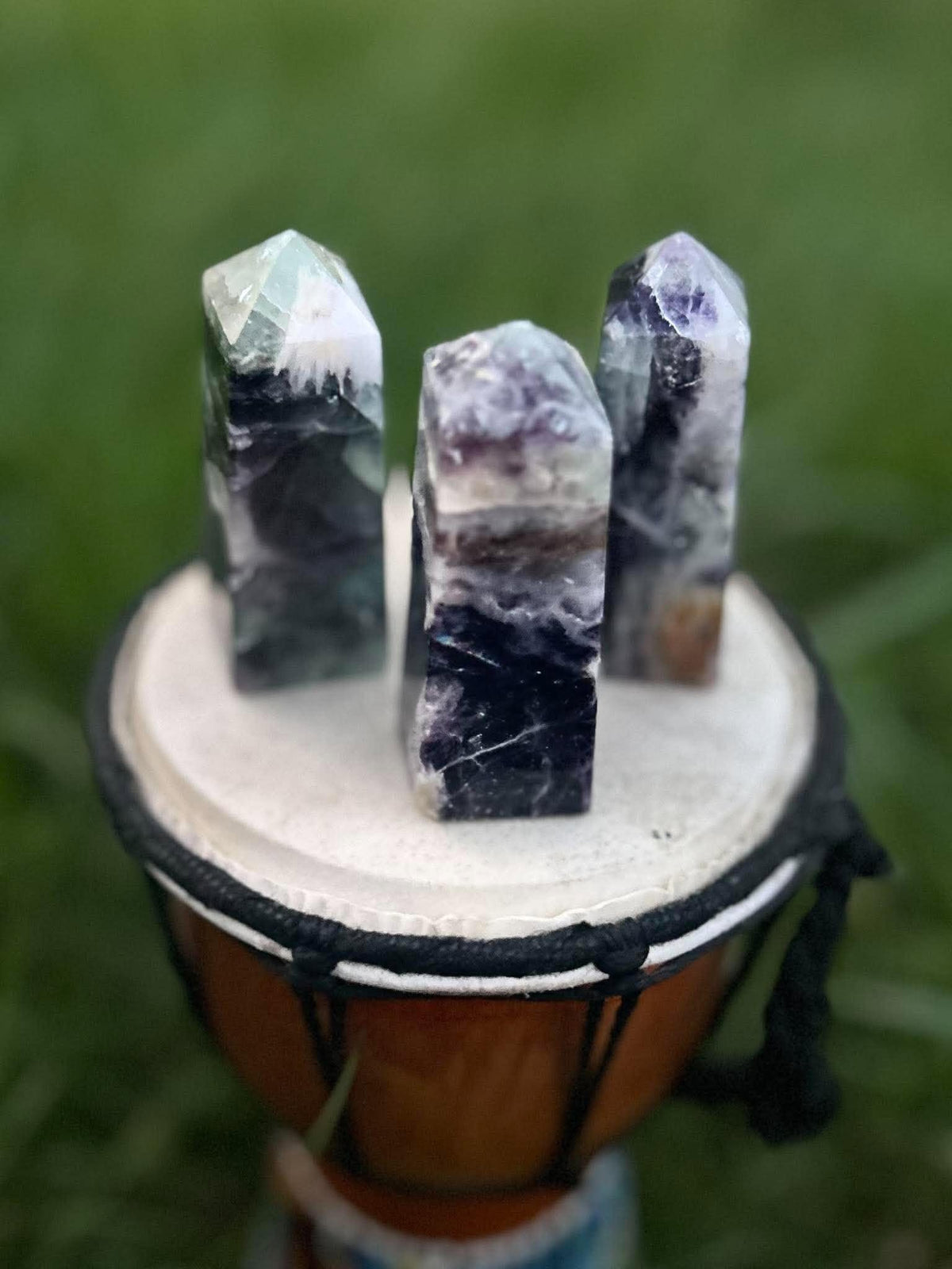 Close-up of Rainbow Fluorite crystal towers with natural purple and green banding and polished points