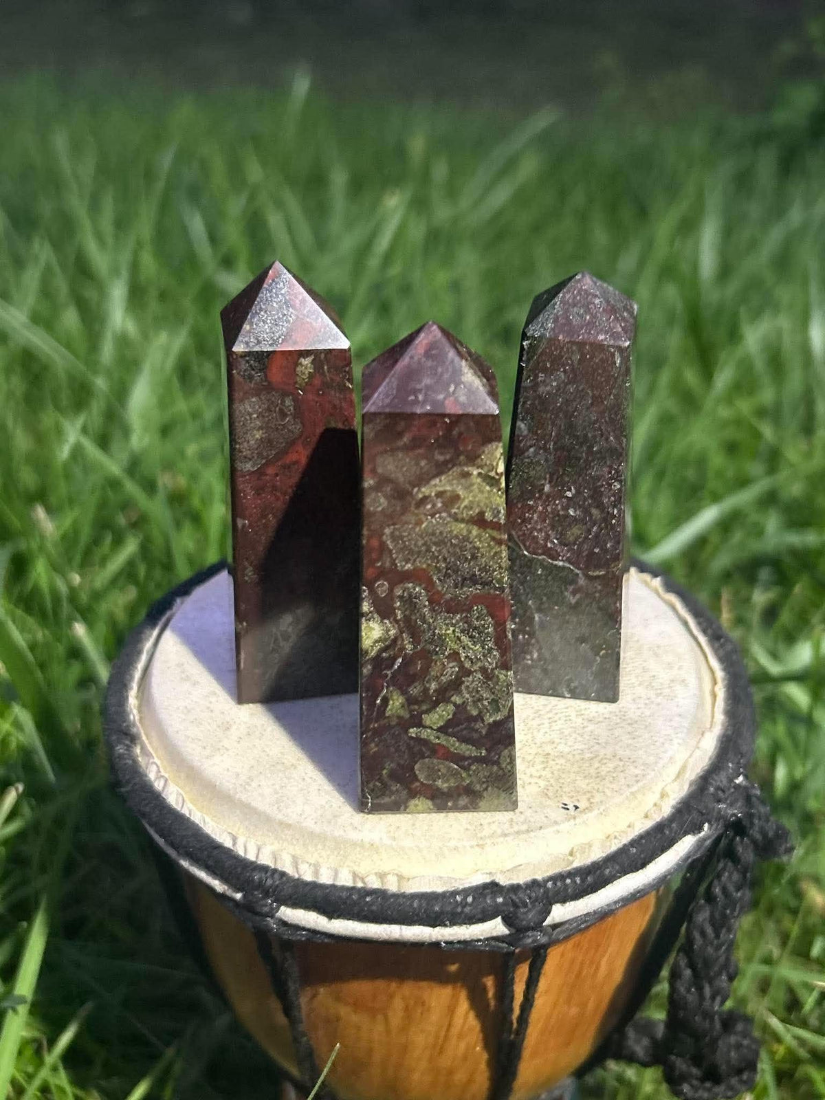 Three Dragon Blood Jasper towers showing unique green and red natural stone patterns in sunlight