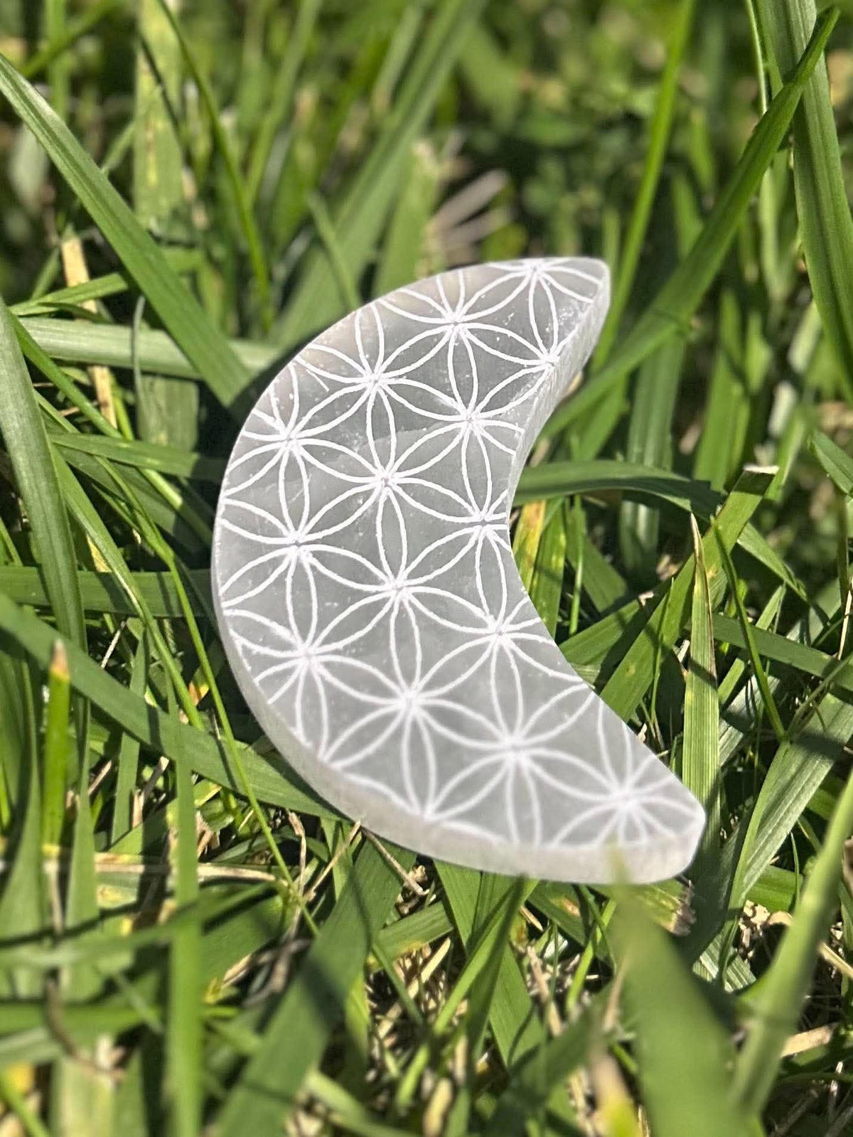 Selenite crescent moon with etched Flower of Life sacred geometry design