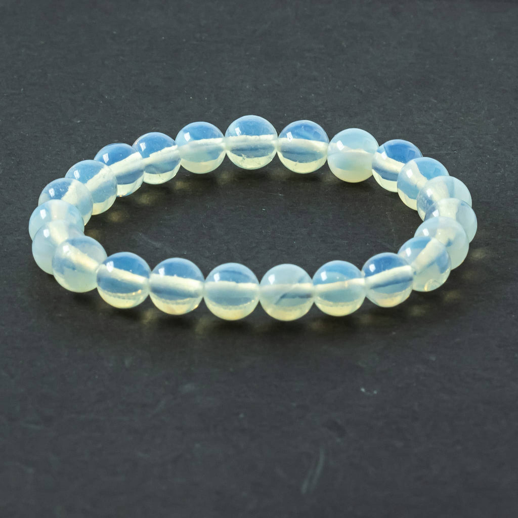 Close-up of polished Opalite beads showing soft blue and pink flashes