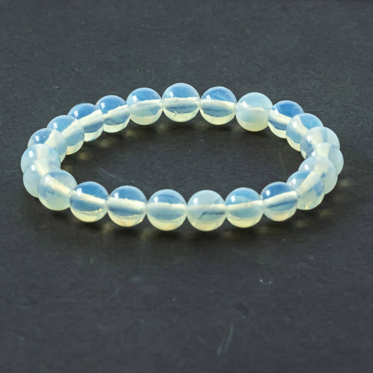 Close-up of polished Opalite beads showing soft blue and pink flashes