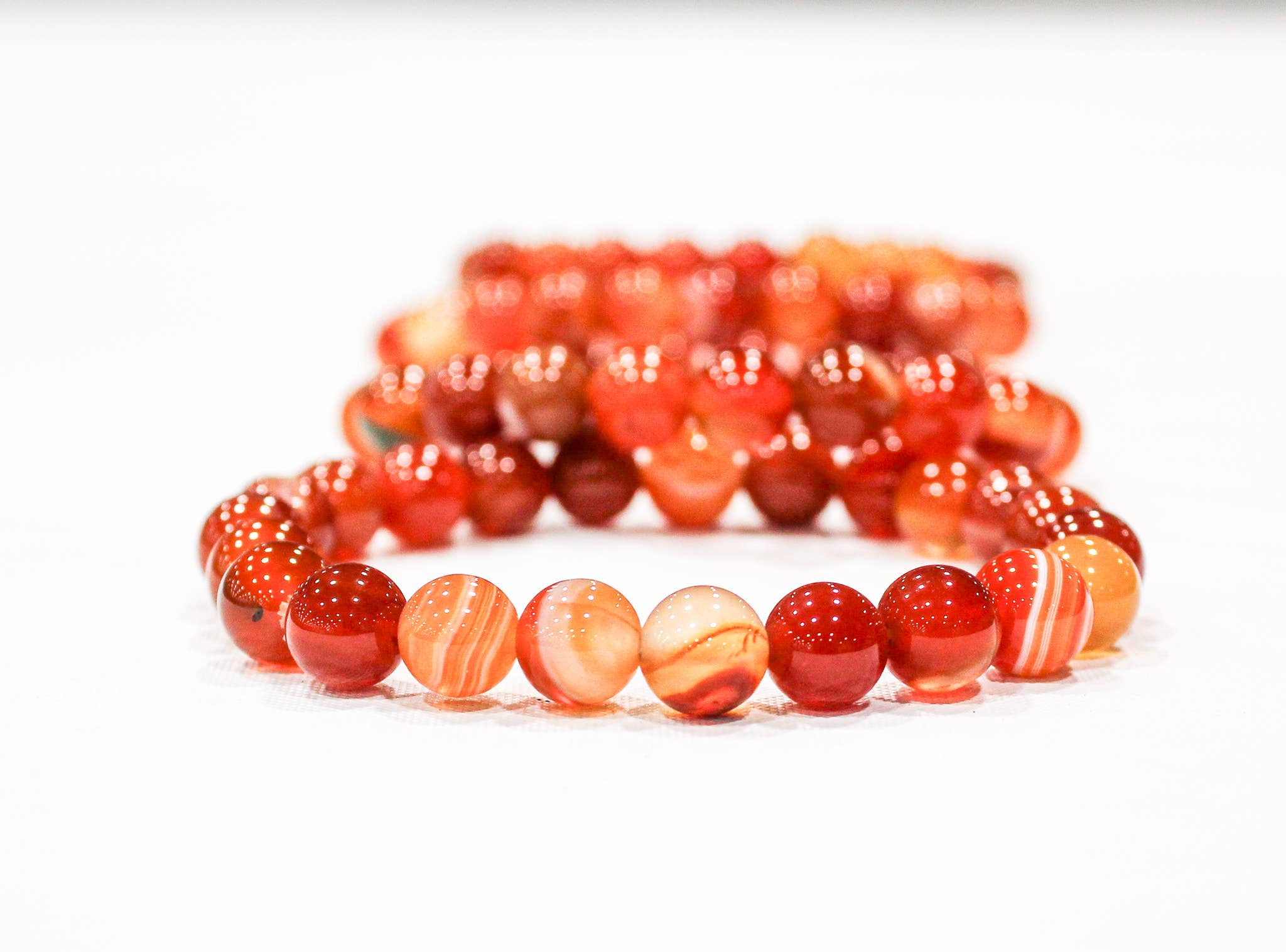 Close-up of polished Banded Carnelian beads showing distinctive natural banding
