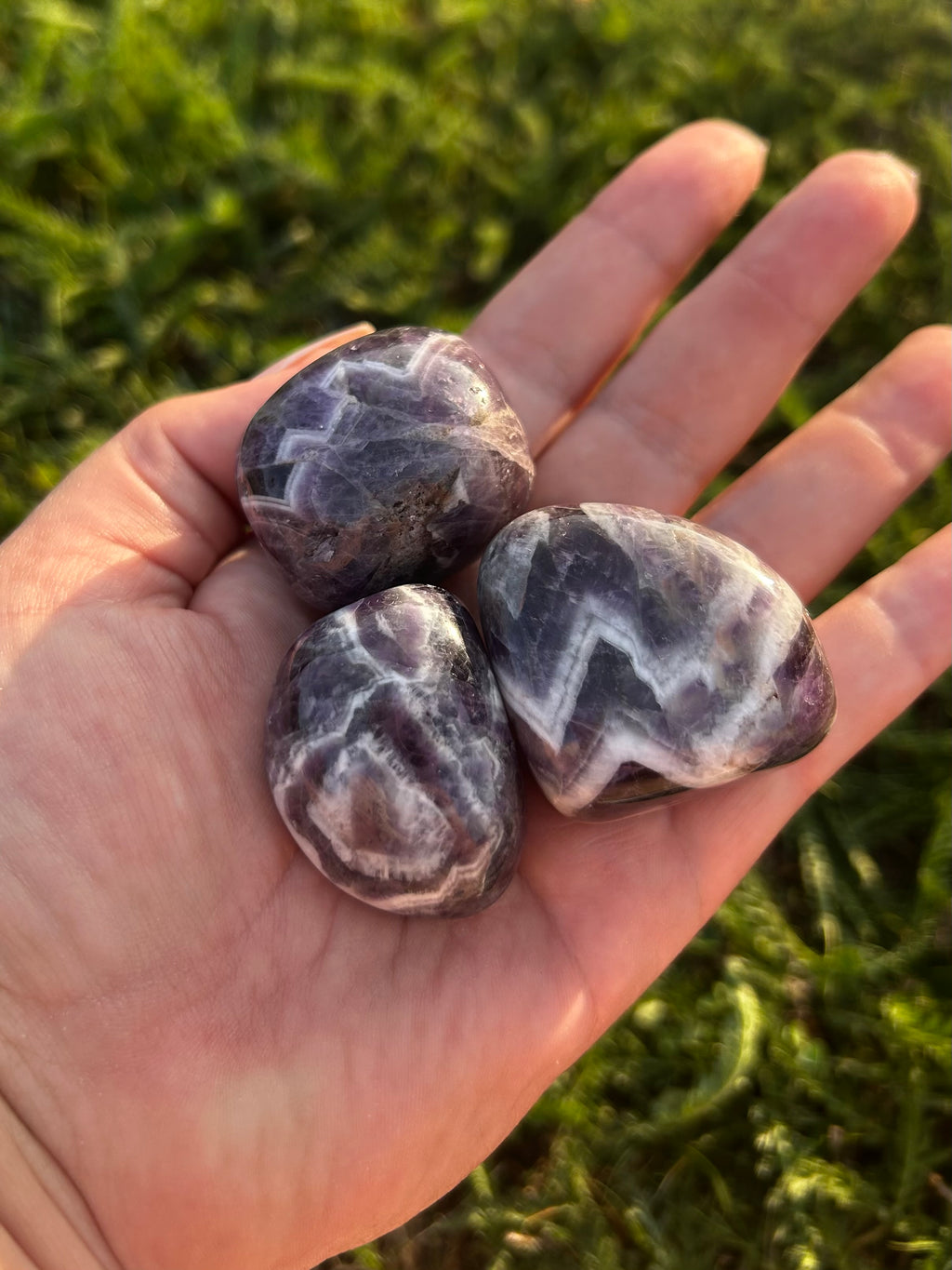 Large polished Chevron Amethyst tumbled stones with distinctive V-shaped patterns