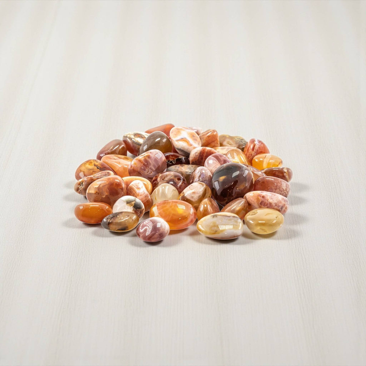 Natural Fire Agate tumbled stone with polished red, orange, and brown tones