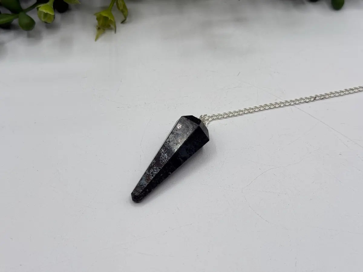 Hematite pendulum with metallic dark gray faceted point and silver-plated chain