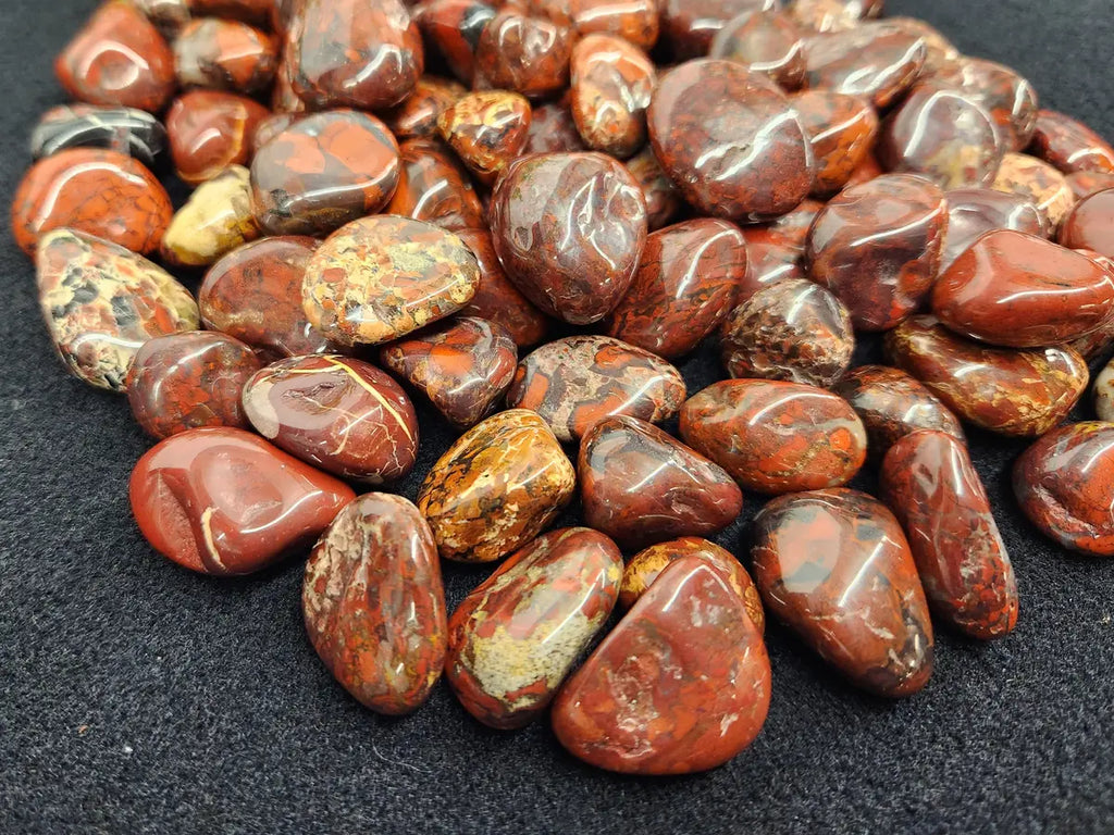 Brecciated Jasper tumbled stone with red, brown, and cream natural patterns