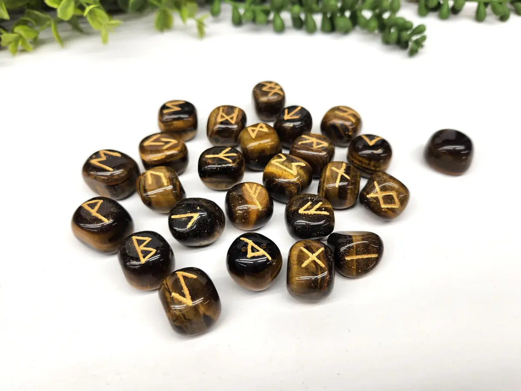 Polished Tiger Eye rune stones with gold Elder Futhark symbols and natural golden brown banding