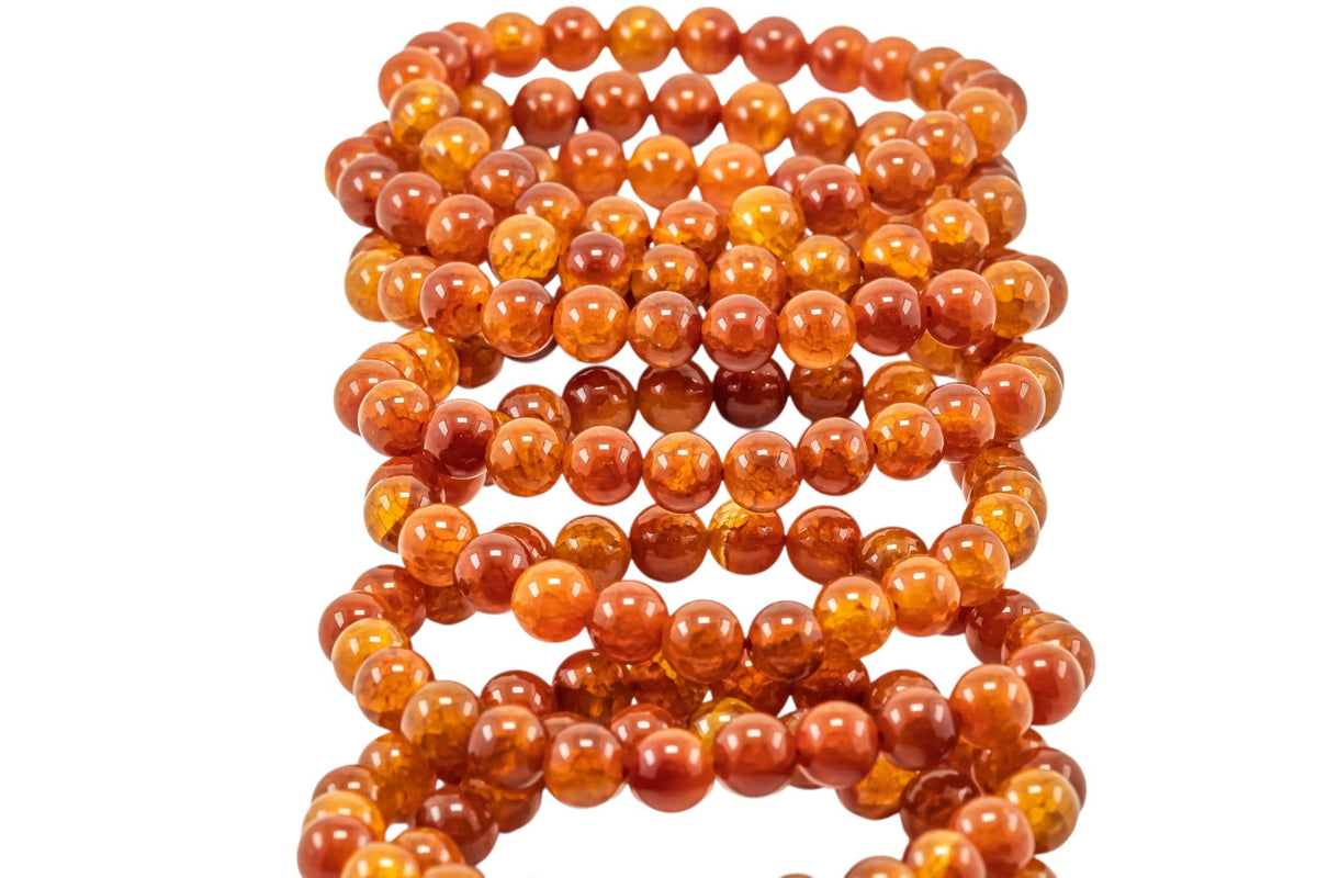 Close-up of polished Fire Agate beads showing natural color variations and flashes