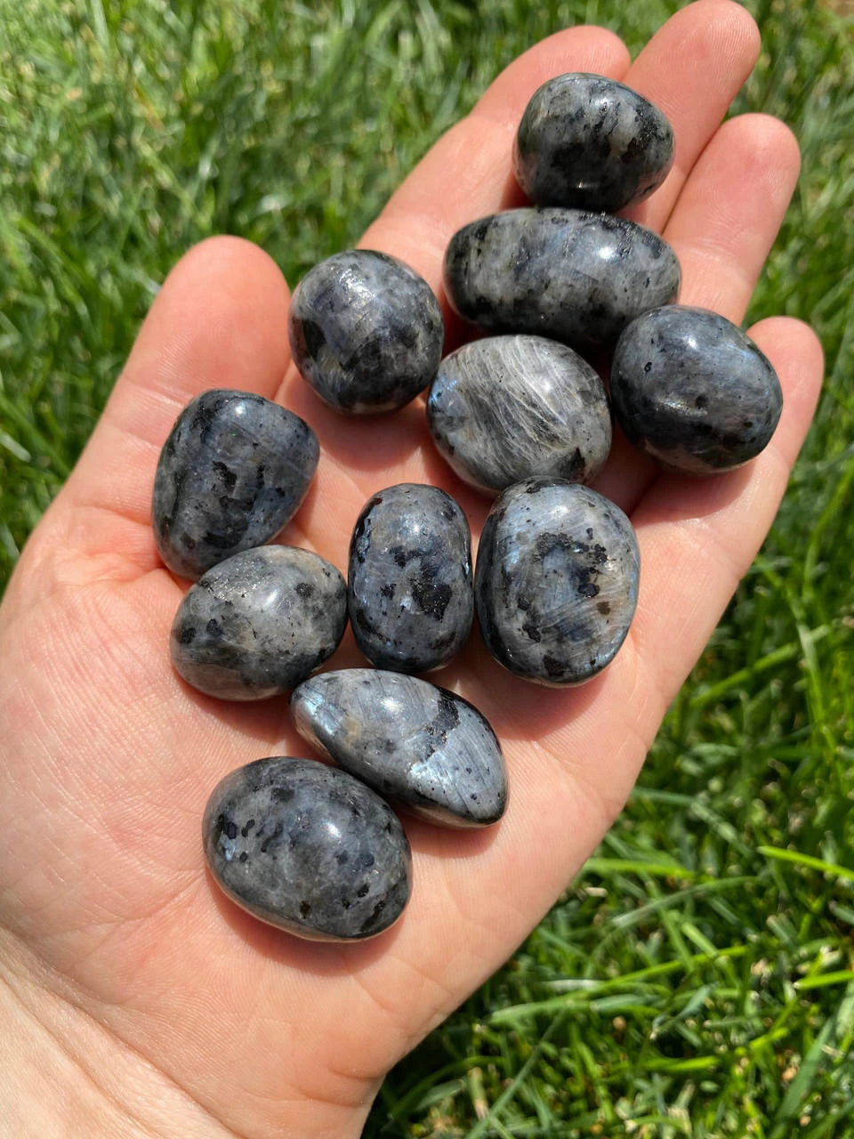 Polished Larvikite stone with dark gray coloring and blue shimmer